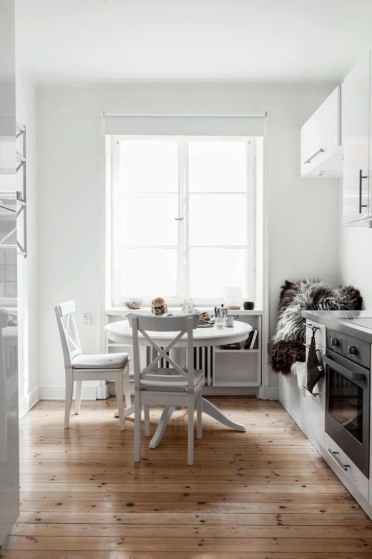 white kitchen with wooden floor 