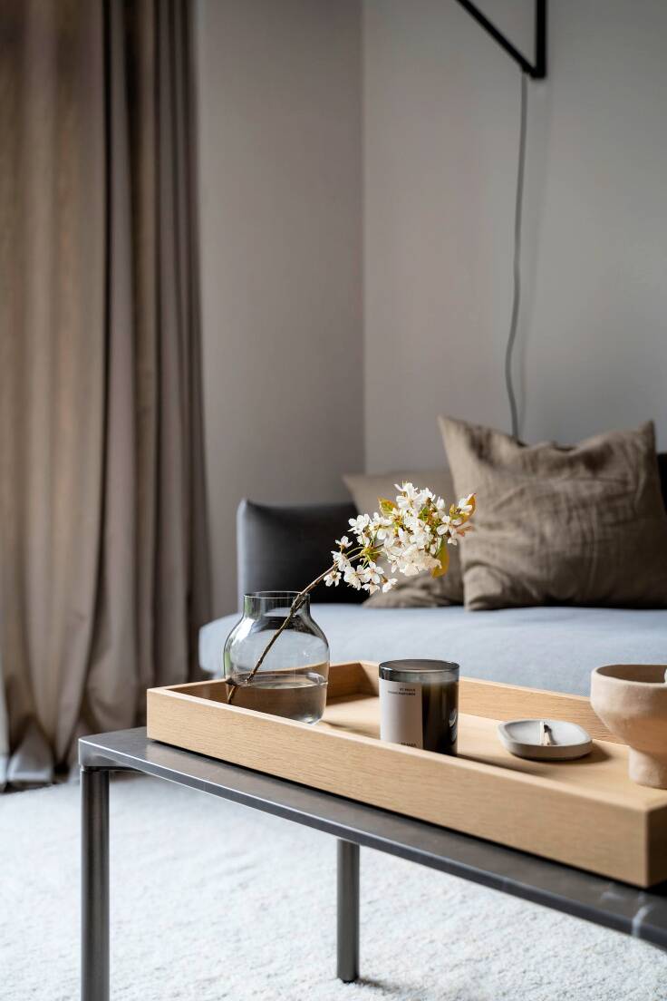simple ways to decorate your home with beautiful Spring blossoms- a branch in a minimalist vase on a Nordic inspired coffee table