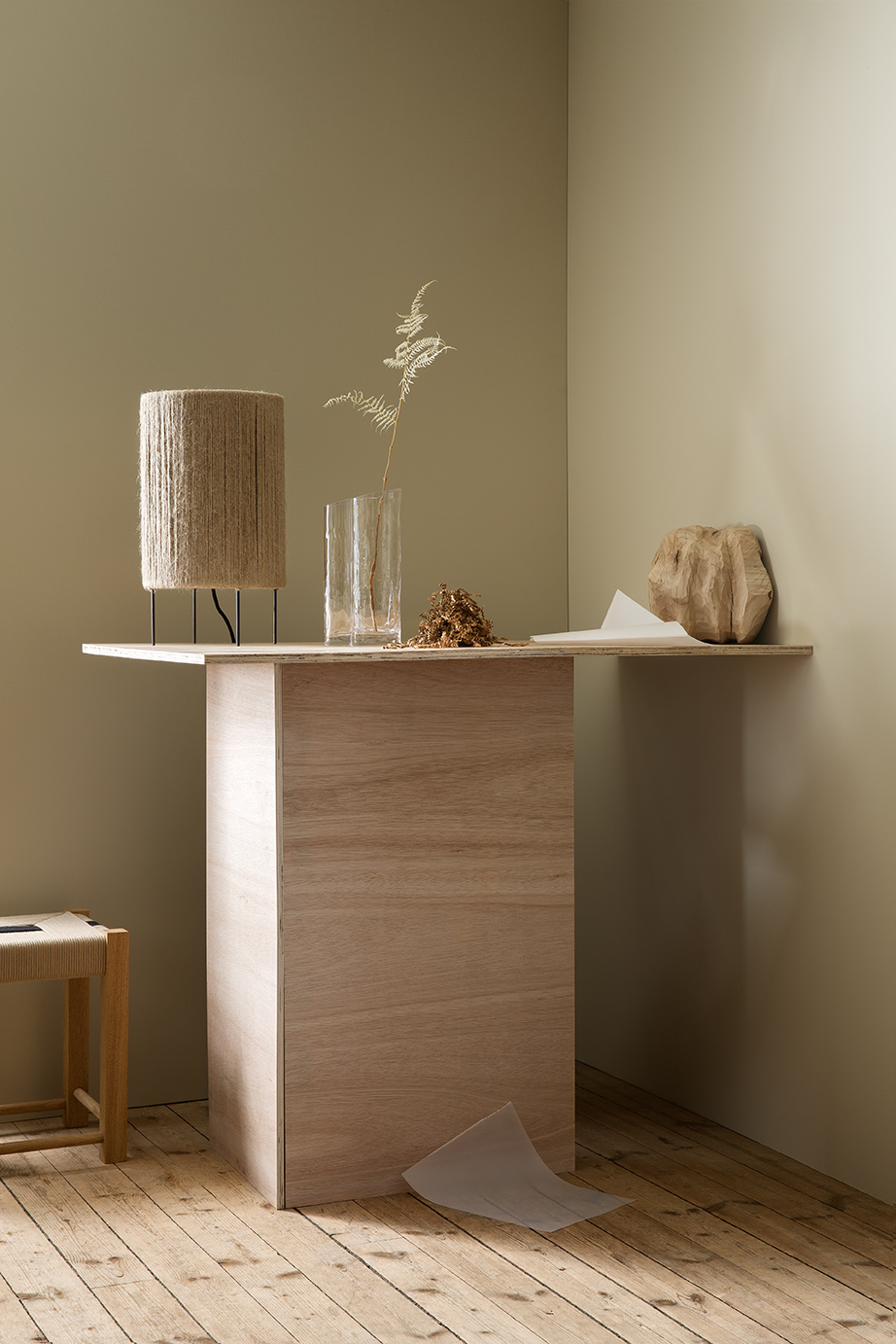 Neutral coloured walls with handmade accessories made by artists on a wooden table