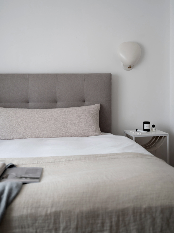 Neutral bedroom with tactile bouclé bolster cushion DIY.