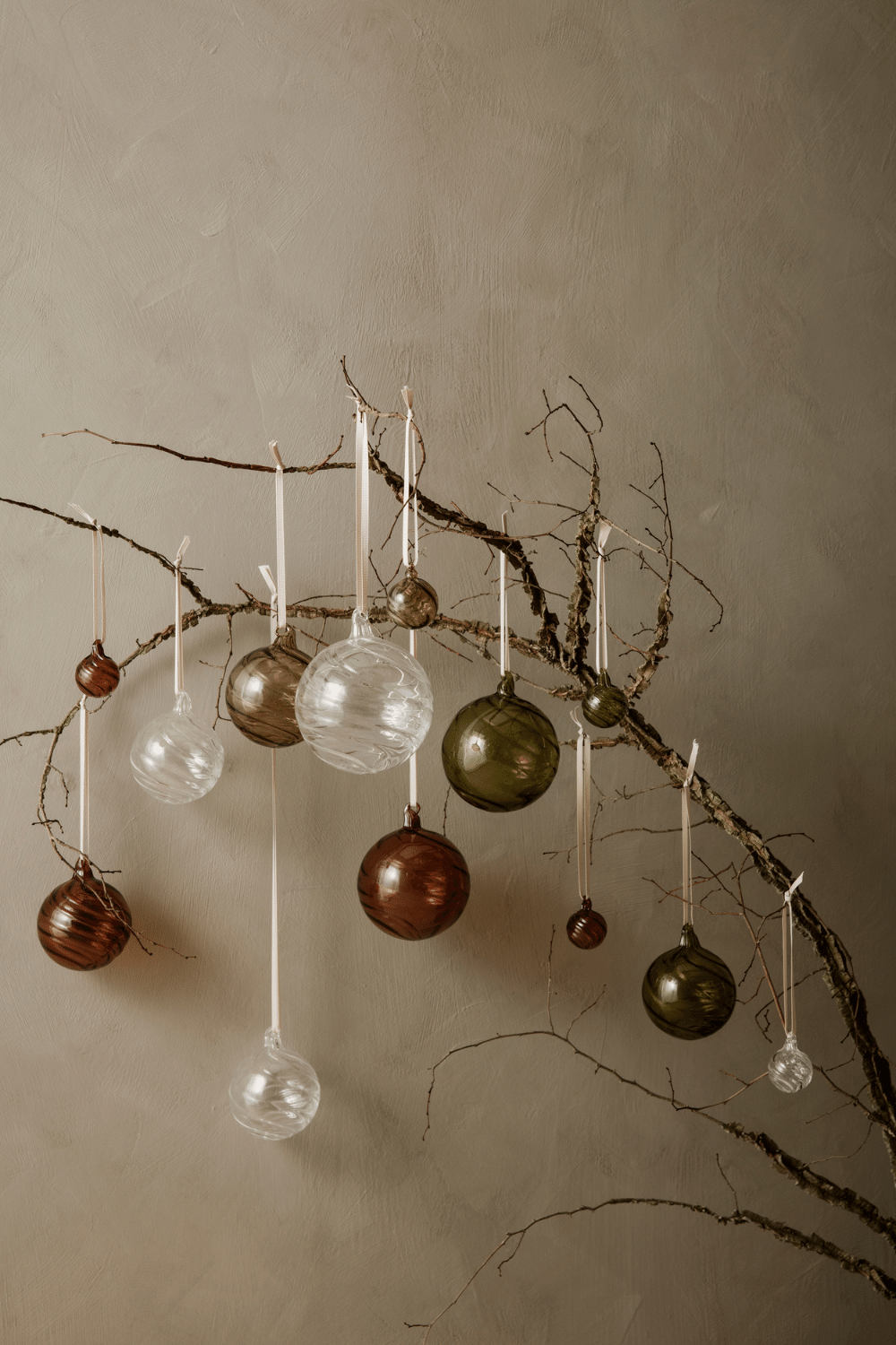 beautiful glass baubles hanging on a tree branch